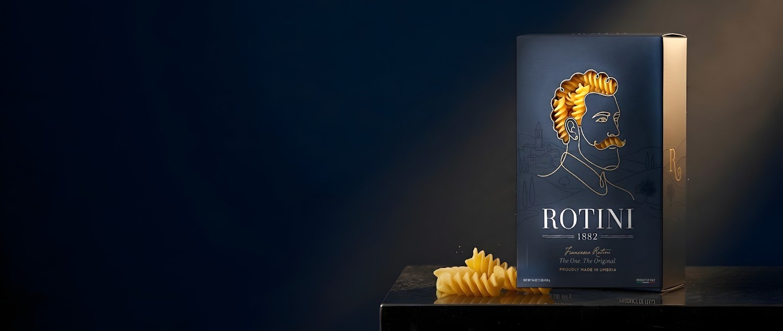 The Rotini 1882 box on travertine stone with a linen napkin and giant fusilloni